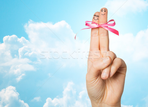 Stock photo: close up of two fingers tied by pink bow knot