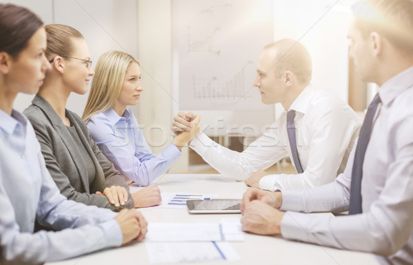 businesswoman and businessman arm wrestling Stock photo © dolgachov