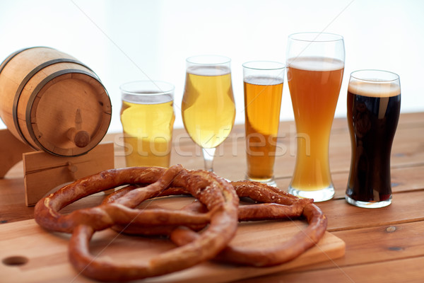 Stock photo: close up of beer glasses, barrel and pretzels