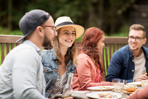 happy friends having dinner at summer garden party Stock photo © dolgachov