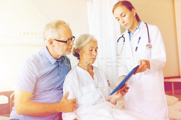 Stock photo: senior woman and doctor with tablet pc at hospital