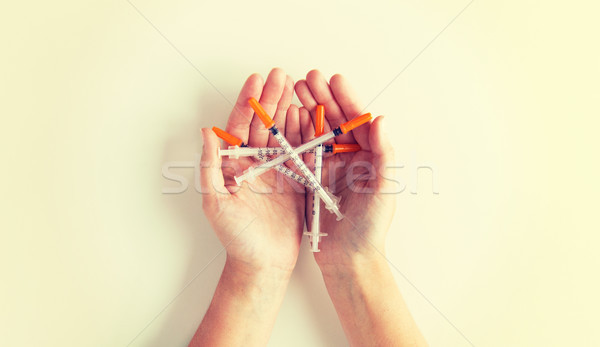 close up of woman hands holding syringes Stock photo © dolgachov