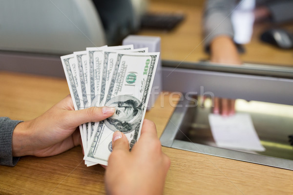 hands with money at bank office or exchanger Stock photo © dolgachov