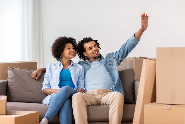 happy couple with boxes moving to new home Stock photo © dolgachov