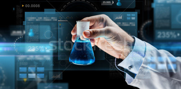 Közelkép tudós tart flaska vegyi tudomány Stock fotó © dolgachov