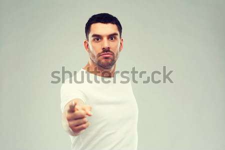 angry man pointing finger to you over gray Stock photo © dolgachov