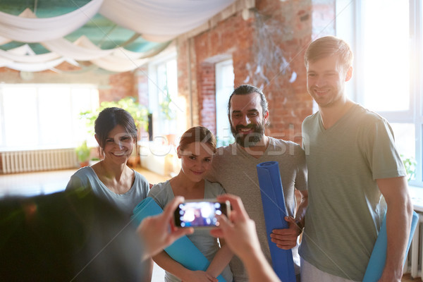 happy people at yoga studio or gym photographing Stock photo © dolgachov