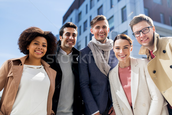 group of happy people or friends on city street Stock photo © dolgachov