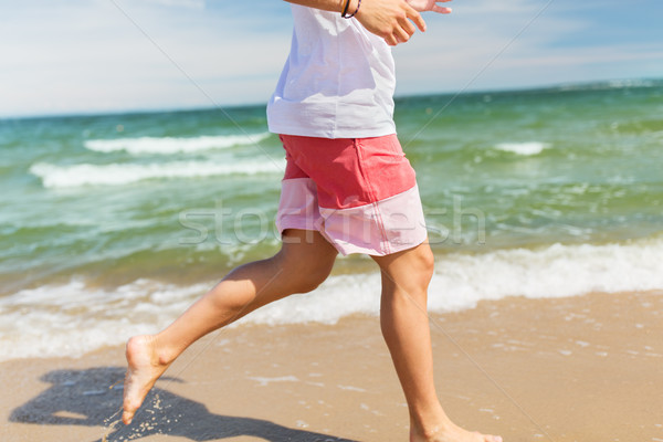 happy man running along summer beach Stock photo © dolgachov