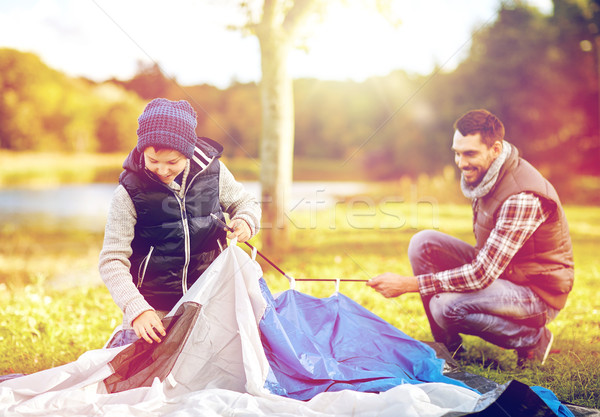 happy father and son setting up tent outdoors Stock photo © dolgachov