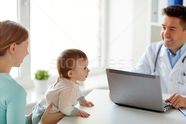 woman with baby and doctor with laptop at clinic Stock photo © dolgachov