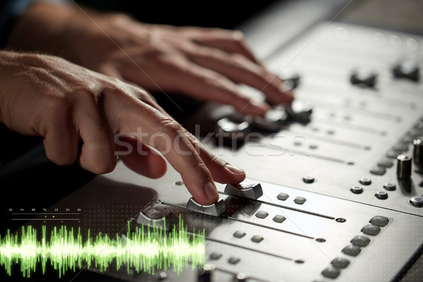hands on mixing console at sound recording studio Stock photo © dolgachov