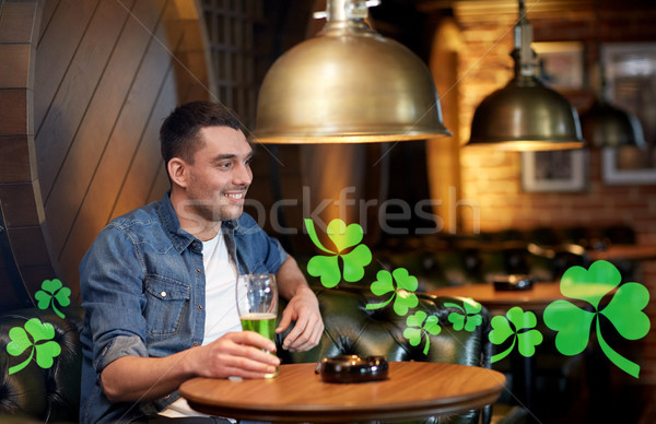 man drinking green beer at bar or pub Stock photo © dolgachov