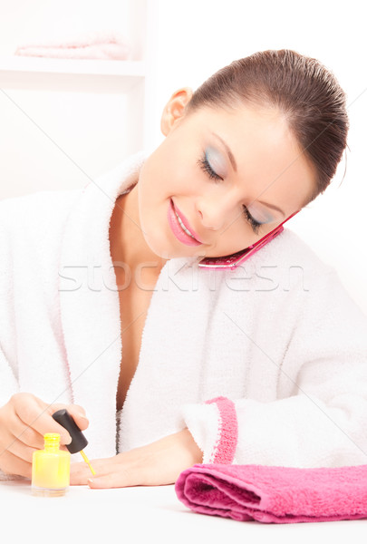 Stock photo: woman polishing her nails