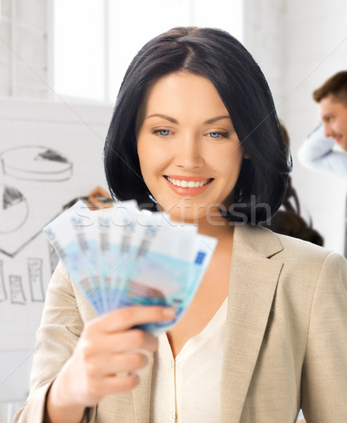 happy businesswoman with cash money in office Stock photo © dolgachov