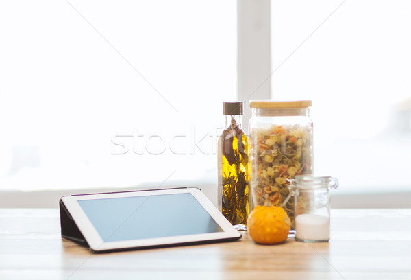 close up of tablet pc olive oil, pasta and pumpkin Stock photo © dolgachov