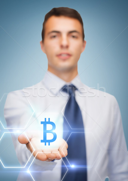 Stock photo: friendly buisnessman showing bit coin on the palm