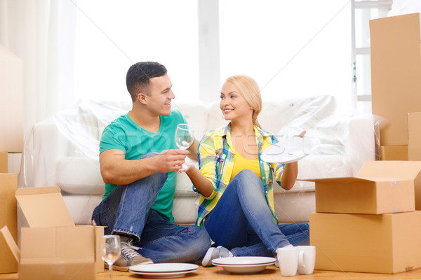 smiling couple unpaking boxes with kitchenware Stock photo © dolgachov