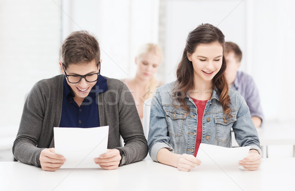 Stock photo: two teenagers looking at test or exam results