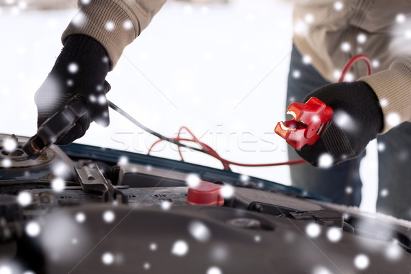 closeup of man under bonnet with starter cables Stock photo © dolgachov