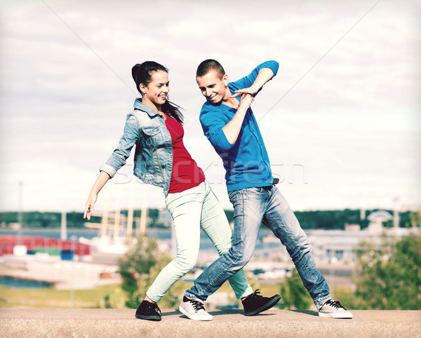 couple of teenagers dancing outside Stock photo © dolgachov