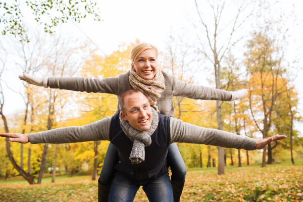 Stock photo: smiling couple having fun in autumn park