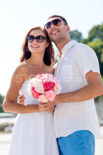 smiling couple in city Stock photo © dolgachov