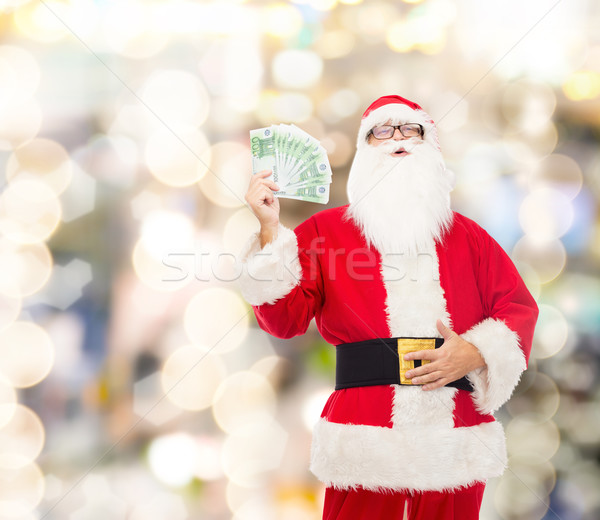 man in costume of santa claus with euro money Stock photo © dolgachov