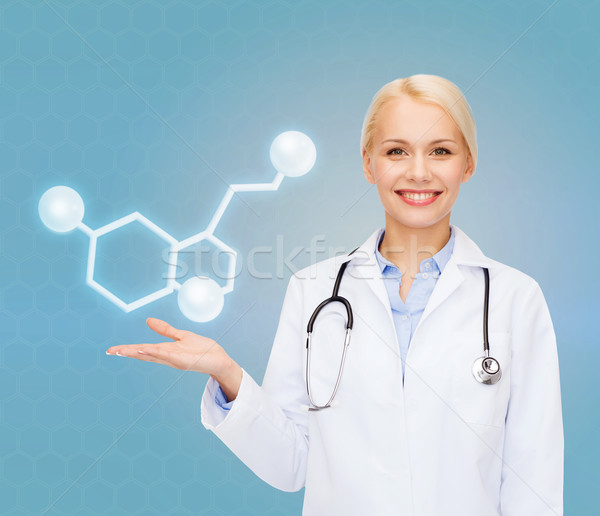 Stock photo: smiling female doctor pointing to molecule