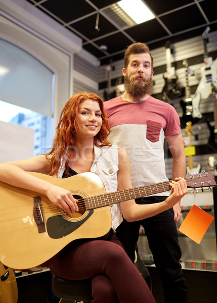 Stock photo: couple of musicians with guitar at music store