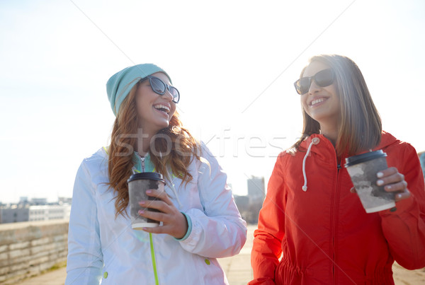 Stock photo: happy teenage girls with coffee cups on street