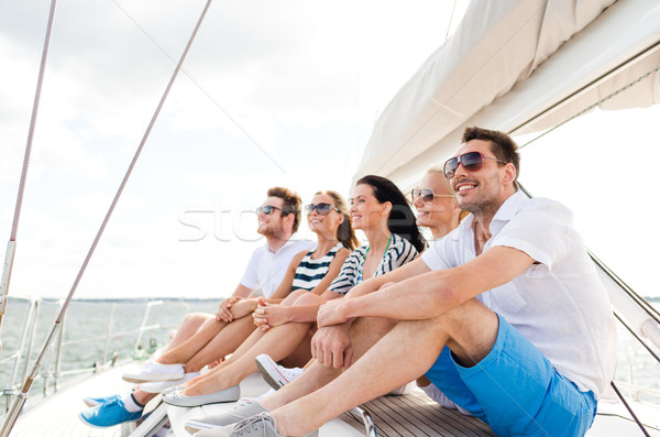 smiling friends sitting on yacht deck Stock photo © dolgachov