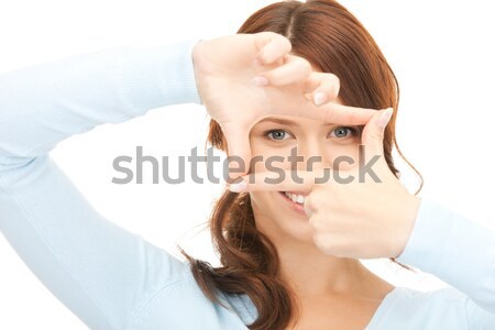 lovely woman looking through hole from fingers Stock photo © dolgachov