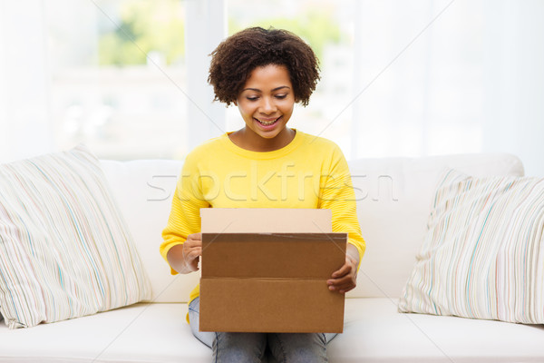 happy african young woman with parcel box at home Stock photo © dolgachov