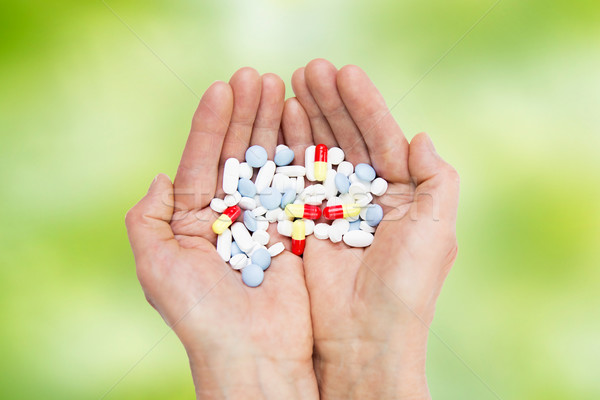 close up of senior woman hands with pills Stock photo © dolgachov