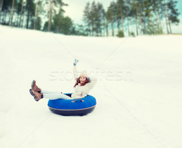 happy teenage girl sliding down on snow tube Stock photo © dolgachov