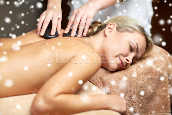 close up of woman having hot stone massage in spa Stock photo © dolgachov