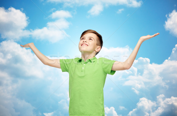 happy boy in polo t-shirt raising hands up Stock photo © dolgachov