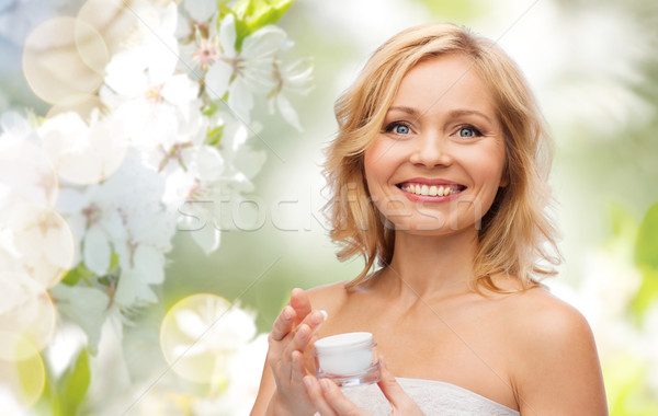Stock photo: happy woman with cream jar