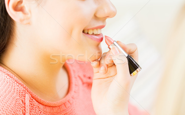 close up of hand applying lipstick to woman lips Stock photo © dolgachov