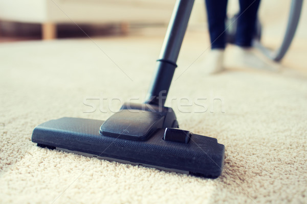 close up of woman legs with vacuum cleaner at home Stock photo © dolgachov