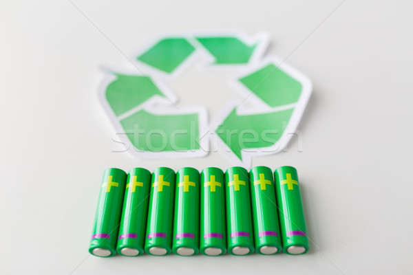 Stock photo: close up of batteries and green recycling symbol