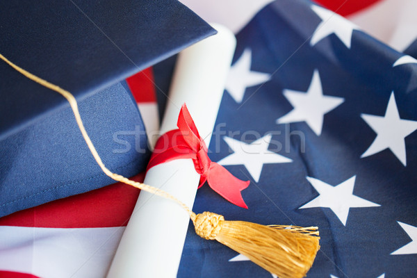 bachelor hat and diploma on american flag Stock photo © dolgachov