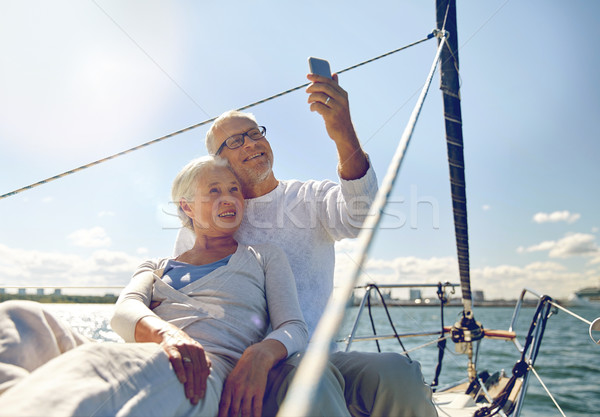Couple de personnes âgées smartphone yacht voile technologie Photo stock © dolgachov