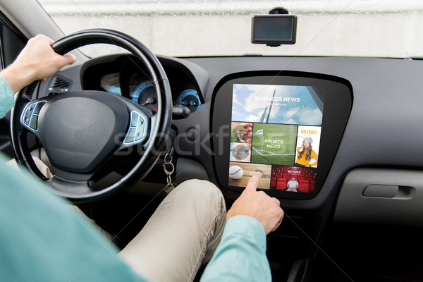 Stock photo: man driving car with news on board computer