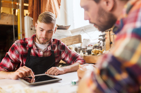 workmen with tablet pc and blueprint at workshop Stock photo © dolgachov