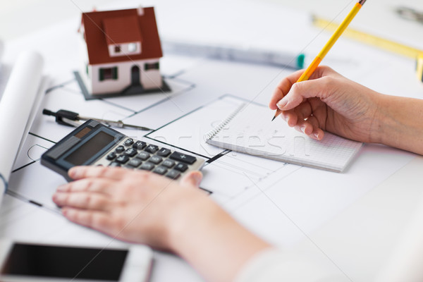 close up of hand on blueprint writing to notebook Stock photo © dolgachov