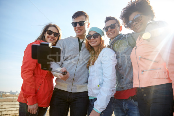 smiling friends taking selfie with smartphone Stock photo © dolgachov