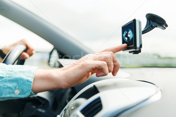 close up of man with gadget on screen driving car Stock photo © dolgachov