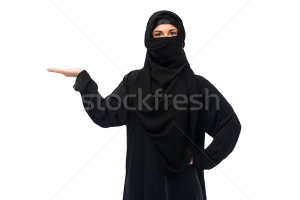 muslim woman in hijab holding empty hand Stock photo © dolgachov